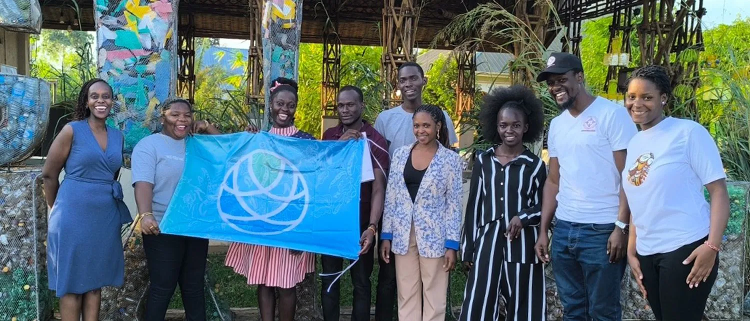 Educators in East Africa with the Contentment Foundation flag